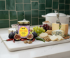 Assorted cheeses, crackers, figs, grapes, and a jar of spicy fig jam on a marble board with a green tiled wall background.
Give the gift of flavor this holiday season! Spicy Fig Jambal blends sweet figs and savory sambal in a small-batch Portland collaboration from Sibeiho and Three Little Figs.