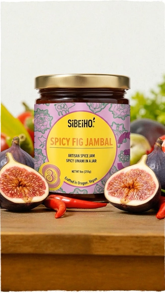 Jar of Sibeho Spicy Fig Jambal with figs and peppers on a wooden surface, Give the gift of flavor this holiday season! Spicy Fig Jambal blends sweet figs and savory sambal in a small-batch Portland collaboration from Sibeiho and Three Little Figs.